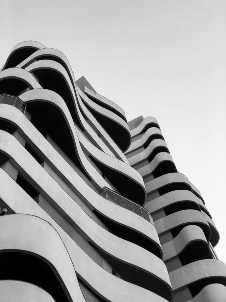 a-black-and-white-photo-of-a-building-wjnx2i14qlu